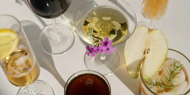 glasses of cocktails decorated with pear and blooming flowers