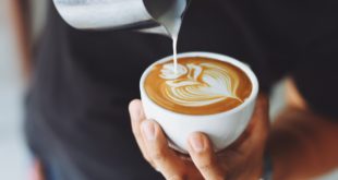 person performing coffee art