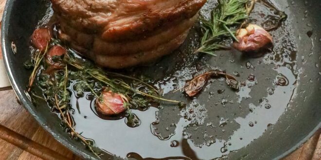 frying pan with piece of meat